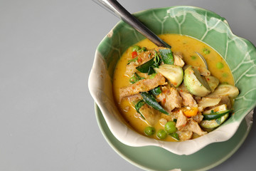 Thai Green pork Curry on a gray background.