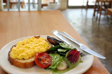 scramble egg on toast with salad.