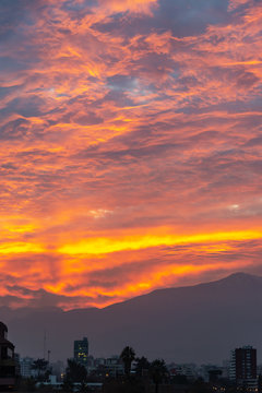 Santiago de Chile, dramatic sky at sunset, andes mountainsin the background