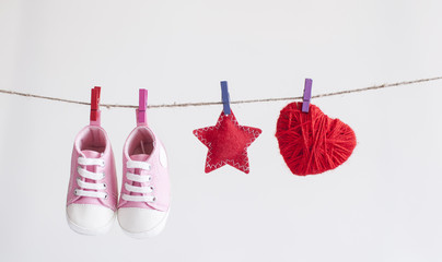 Baby shoes and photo hanging on the clothesline