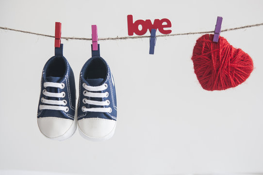 Baby shoes and photo hanging on the clothesline