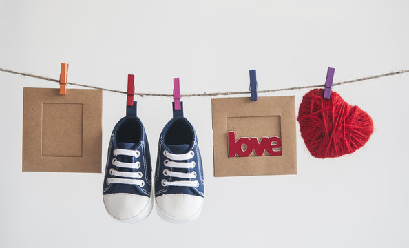 Baby shoes and photo hanging on the clothesline