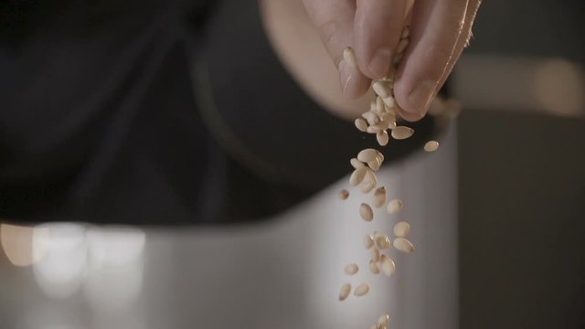 Adding pine nuts into a bow