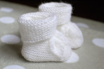 Fototapeta na wymiar two baby white socks closeup on white background