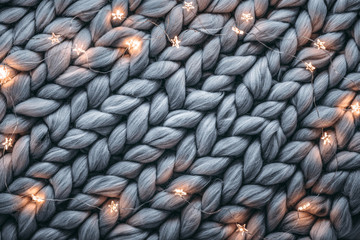 Christmas lights on warm woolen sweater