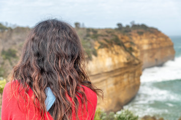 Fototapeta na wymiar Woman looking at powerful sea waves against rocks