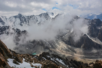 Scenic alpine landscape with and mountain ranges. natural mountain pastures and snow-capped mountain tops in the background. National park of Kyrgyzstan. Nice view.