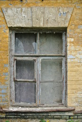 window of an old house with broken glass