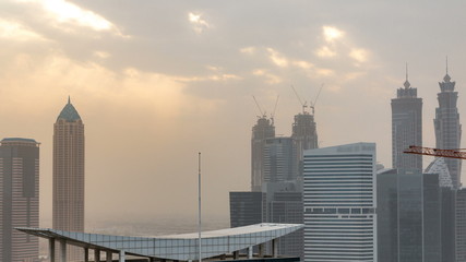 Fototapeta na wymiar Dubai business bay towers at sunset aerial timelapse.
