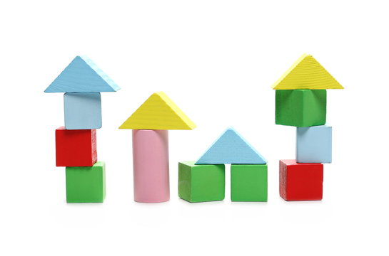 Wooden building blocks for children, made into houses isolated on white background 