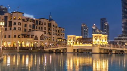 Fototapeta na wymiar The bridge near the biggest musical fountain in Dubai day to night timelapse. Dubai, UAE