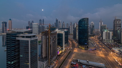 Fototapeta na wymiar Dobai Downtown night to day timelapse. Aerial view over big futuristic city by night.