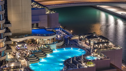 Fototapeta na wymiar View of skyscrapers with swimming pool in Dubai Marina timelapse