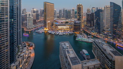 Evening illumination of Dubai Marina day to night aerial timelapse, UAE.