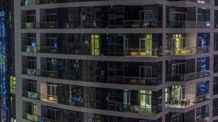 Fototapeta na wymiar Scenic glowing windows of skyscrapers at evening timelapse