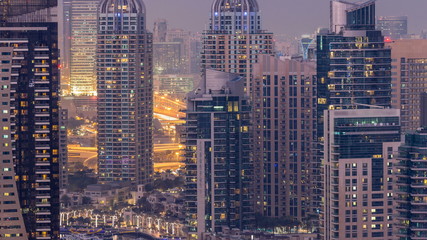 Fototapeta na wymiar Beautiful aerial top view day to night transition timelapse of Dubai Marina