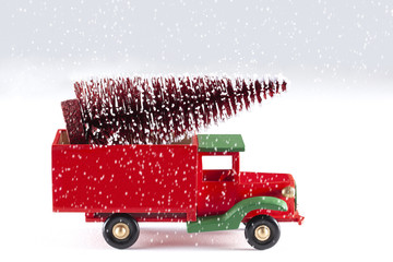 close up on a toy car with christmas tree and snowflakes isolated on white background