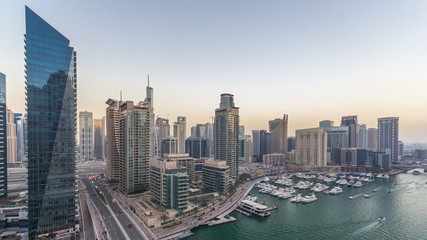 Naklejka premium Beautiful aerial top view day to night transition timelapse of Dubai Marina canal
