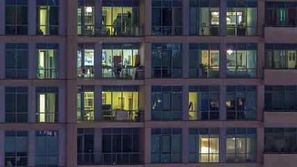 Glowing windows of skyscrapers at evening timelapse