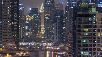 Water canal on Dubai Marina skyline at night timelapse.