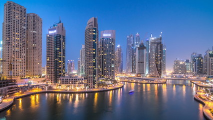 Obraz na płótnie Canvas Beautiful aerial top view day to night transition timelapse of Dubai Marina canal
