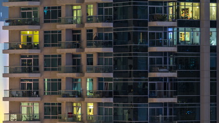 Fototapeta na wymiar Glowing windows of skyscrapers at evening timelapse