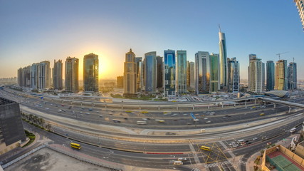 Aerial view of Jumeirah lakes towers skyscrapers at sunrise timelapse with traffic on sheikh zayed road.