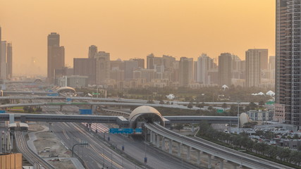 Fototapeta na wymiar Aerial view of Jumeirah lakes towers skyscrapers during sunrise timelapse with traffic on sheikh zayed road.