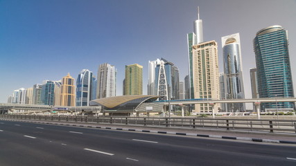 View of Jumeirah lakes towers skyscrapers and metro sration timelapse hyperlapse with traffic on sheikh zayed road.