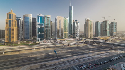 Aerial view of Jumeirah lakes towers skyscrapers timelapse with traffic on sheikh zayed road.