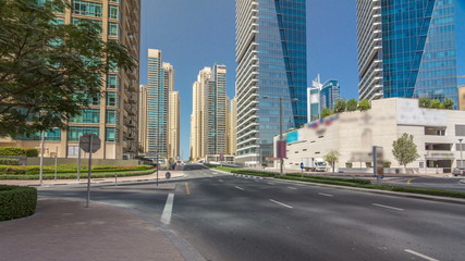 Dubai Marina with Skyscrapers timelapse hyperlapse and traffic on the street near concrete road bridge through the canal