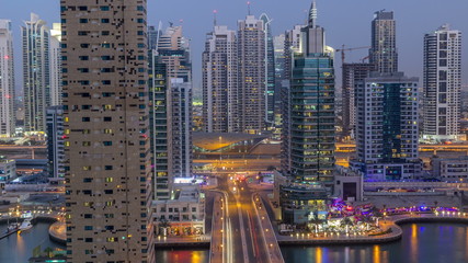 Fototapeta na wymiar Beautiful aerial top view day to night transition timelapse of Dubai Marina canal
