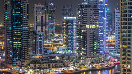 Fototapeta na wymiar Water canal on Dubai Marina skyline at night timelapse.