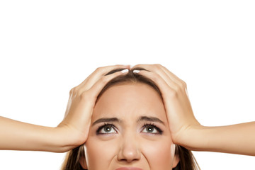Half portrait of young frustrated woman on white background