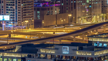 Fototapeta na wymiar Night traffic on a busy intersection on Sheikh Zayed highway aerial timelapse