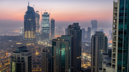 Fototapeta na wymiar Foggy morning in downtown of Dubai night to day timelapse.