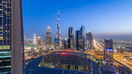 Dubai downtown skyline day to night timelapse with tallest building and Sheikh Zayed road traffic, UAE