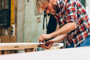 carpenter working an a wood board