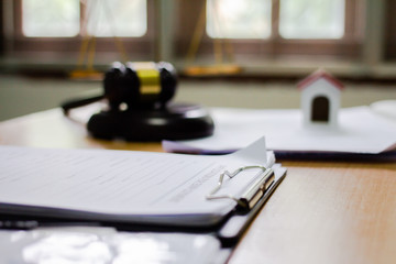 Equipment of the Hammer and Scale law office with contract papers on wood table. Lawyer Concept....