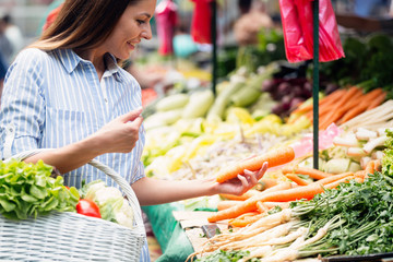 Picture of woman at marketplace buying vegetables