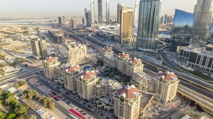 Dubai downtown skyline at sunset timelapse and road traffic near mall, UAE