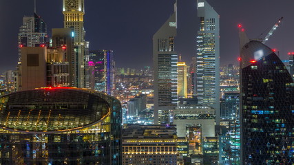 Naklejka premium Skyline view of the buildings of Sheikh Zayed Road and DIFC night timelapse in Dubai, UAE.