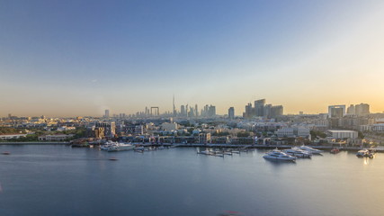 Dubai creek landscape timelapse with boats and ship and modern buildings in the background during sunset - Powered by Adobe