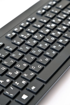 black wireless keyboard with Russian and English letters
