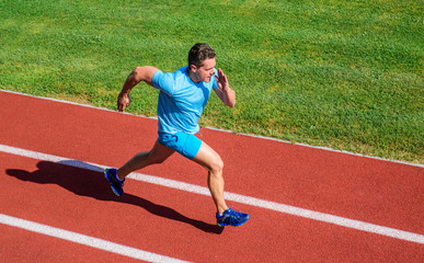 Obraz premium Impulse to move. Athlete run stadium green grass background. Life non stop motion. Runner sporty shape in motion. Sport lifestyle and health concept. Man athlete run to achieve great result