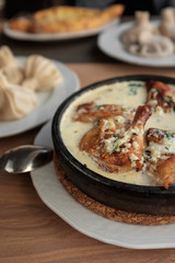 Chicken in a creamy sauce with garlic and herbs, khinkali. 