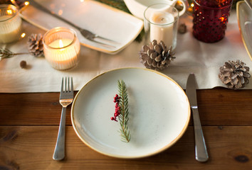 Fototapeta na wymiar christmas, holidays and eating concept - table served for festive dinner at home
