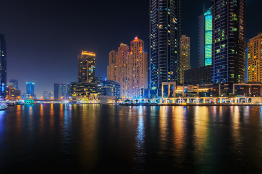 Beautiful view to Dubai Marina Promenade, UAE. Long exposure effect at night