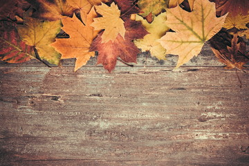 Naklejka na ściany i meble Autumn composition. Frame made of autumn dried leaves on dark wooden vintage background. Autumn, fall, background. Flat lay, top view, copy space 