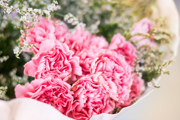 Close up Pink flowers are in bouquet arranged with white flowers and selective focus background
